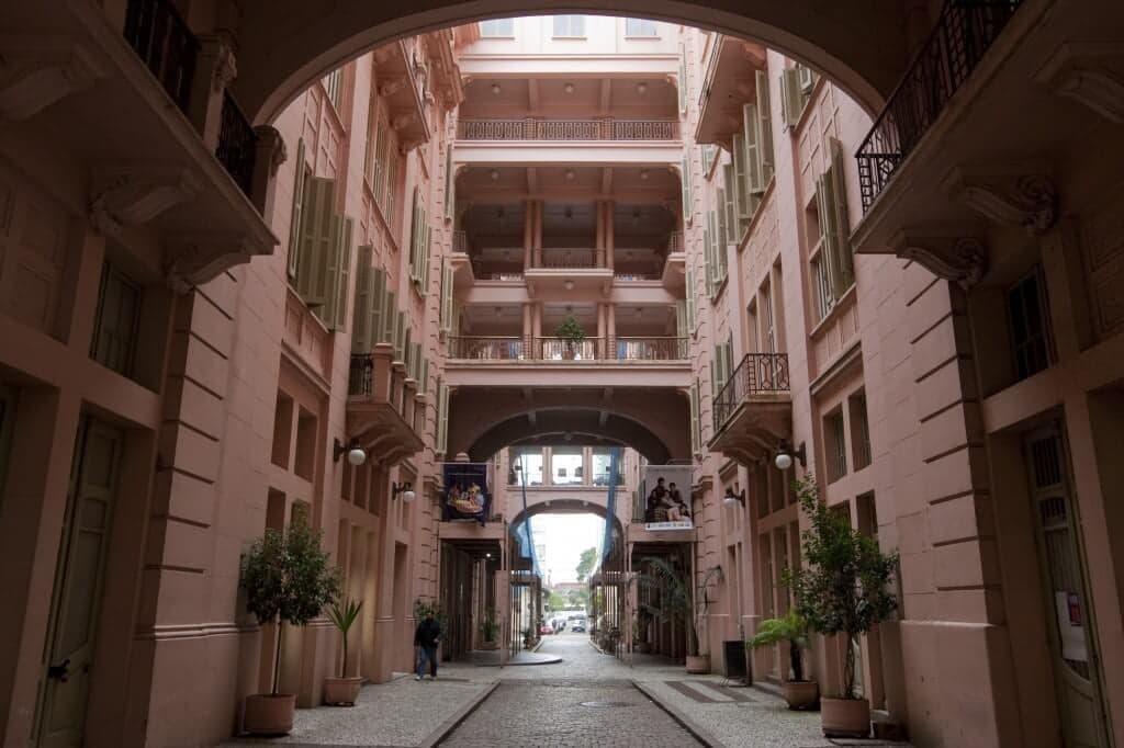 Inner courtyard of the Casa de Cultura Mario Quintana, framed by the pink arcades of its balconies